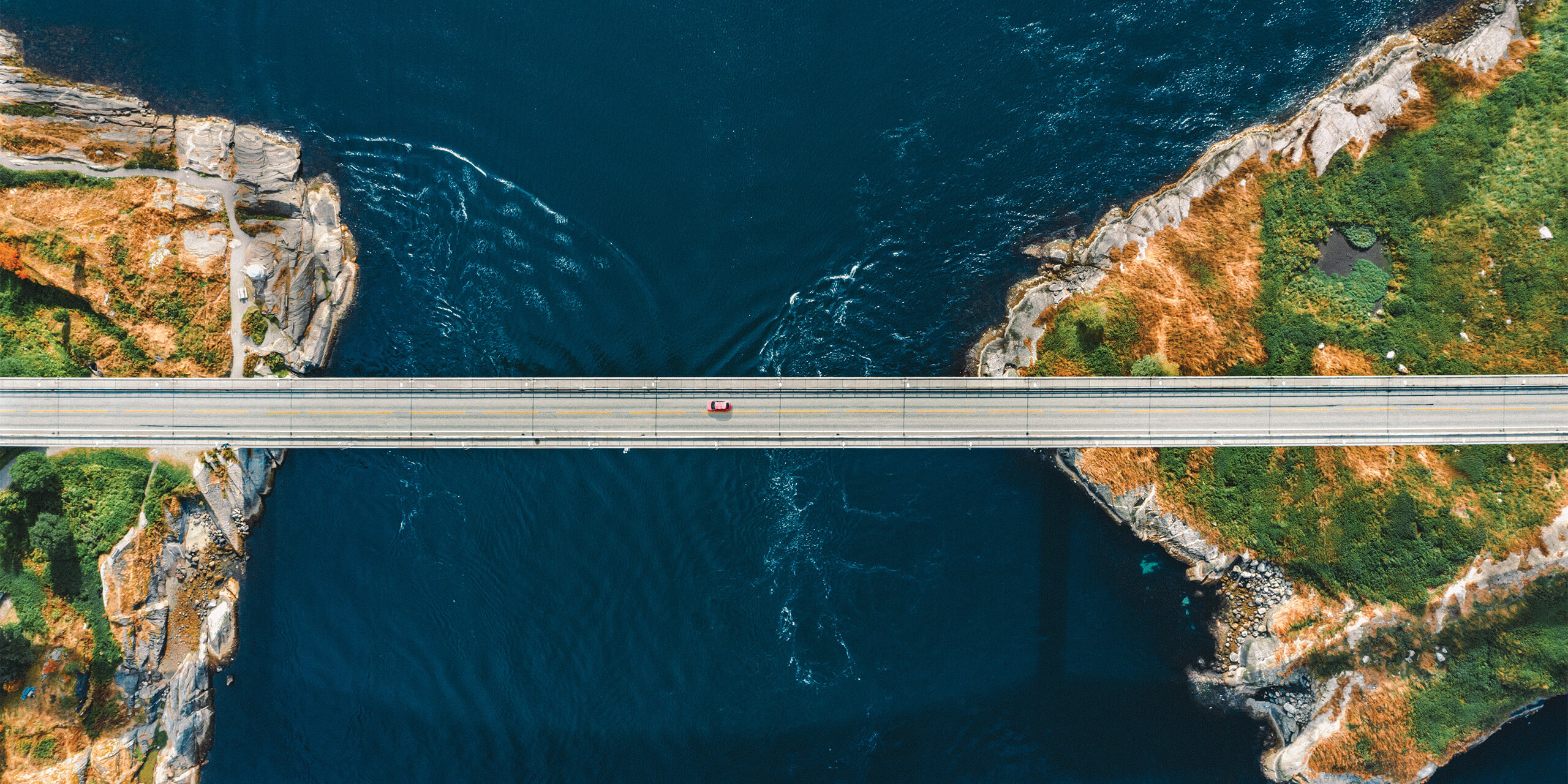 Aerial view of a a bridge connecting islands across the sea