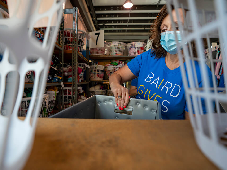 A Baird Trust associate sorting supplies at Home of the Innocents