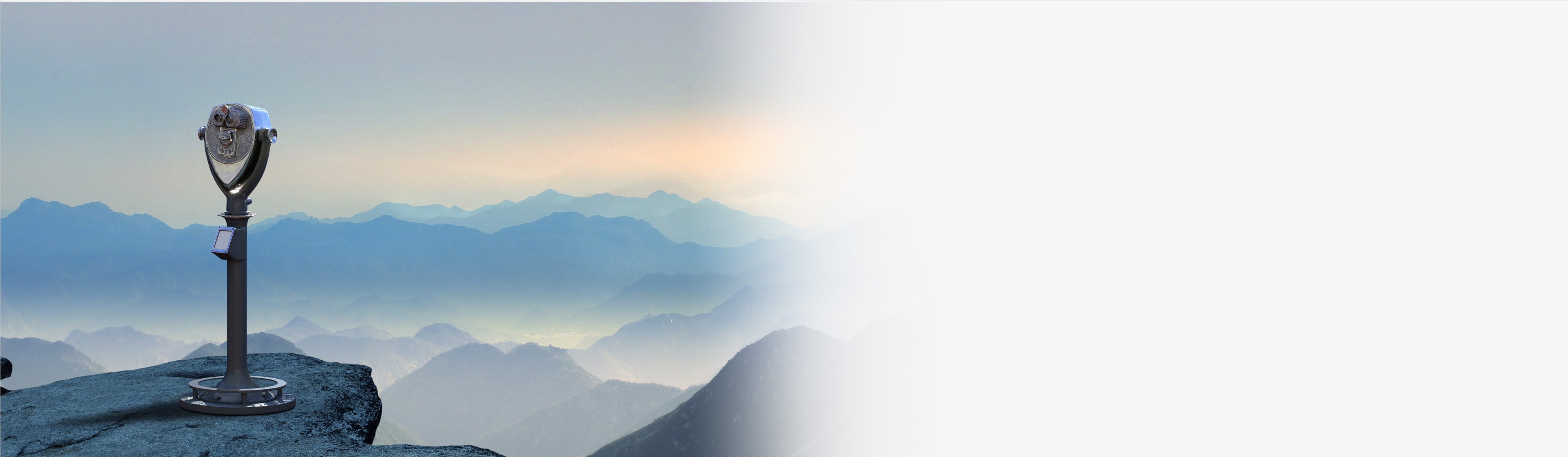 Telescope pointed toward a mountain range.