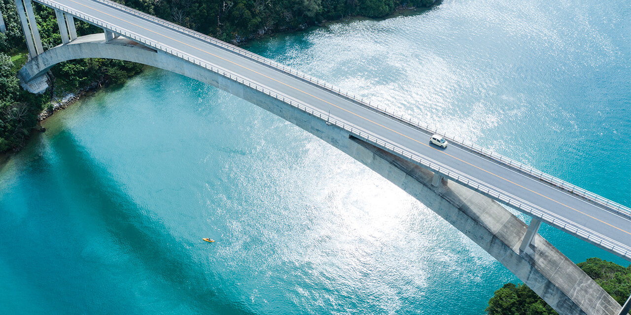 Aerial photo of a bridge over clear blue water