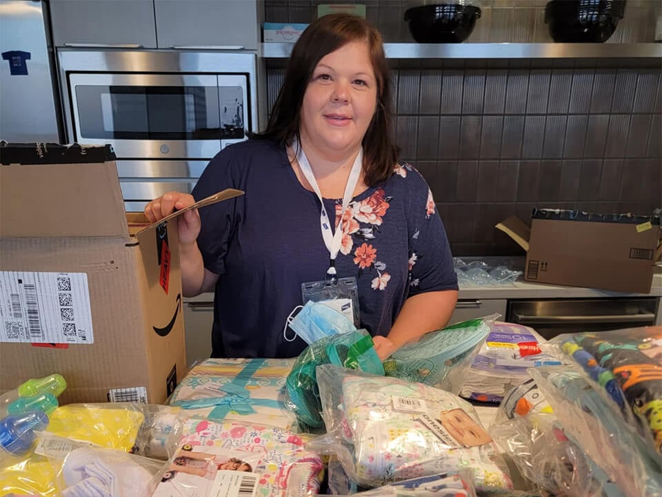 A Baird associate volunteers packing items at Afghan Refugees