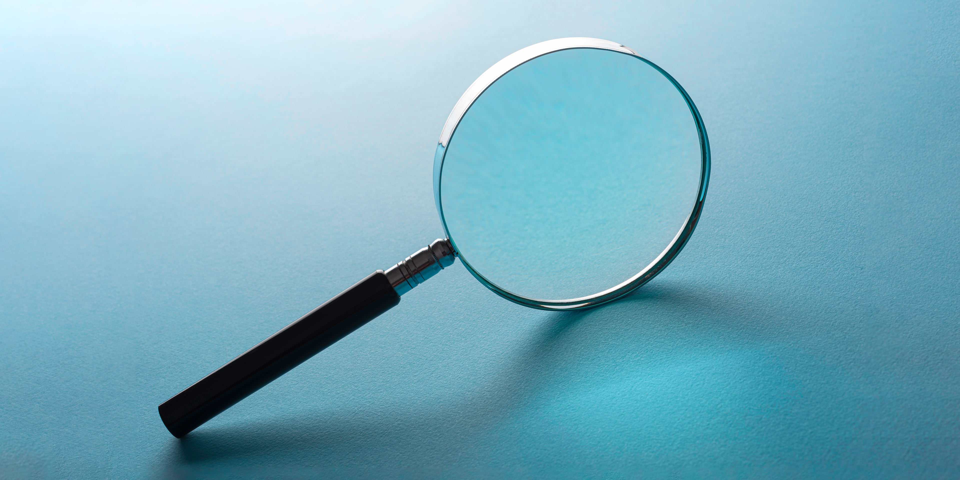 Magnifying glass against a blue background
